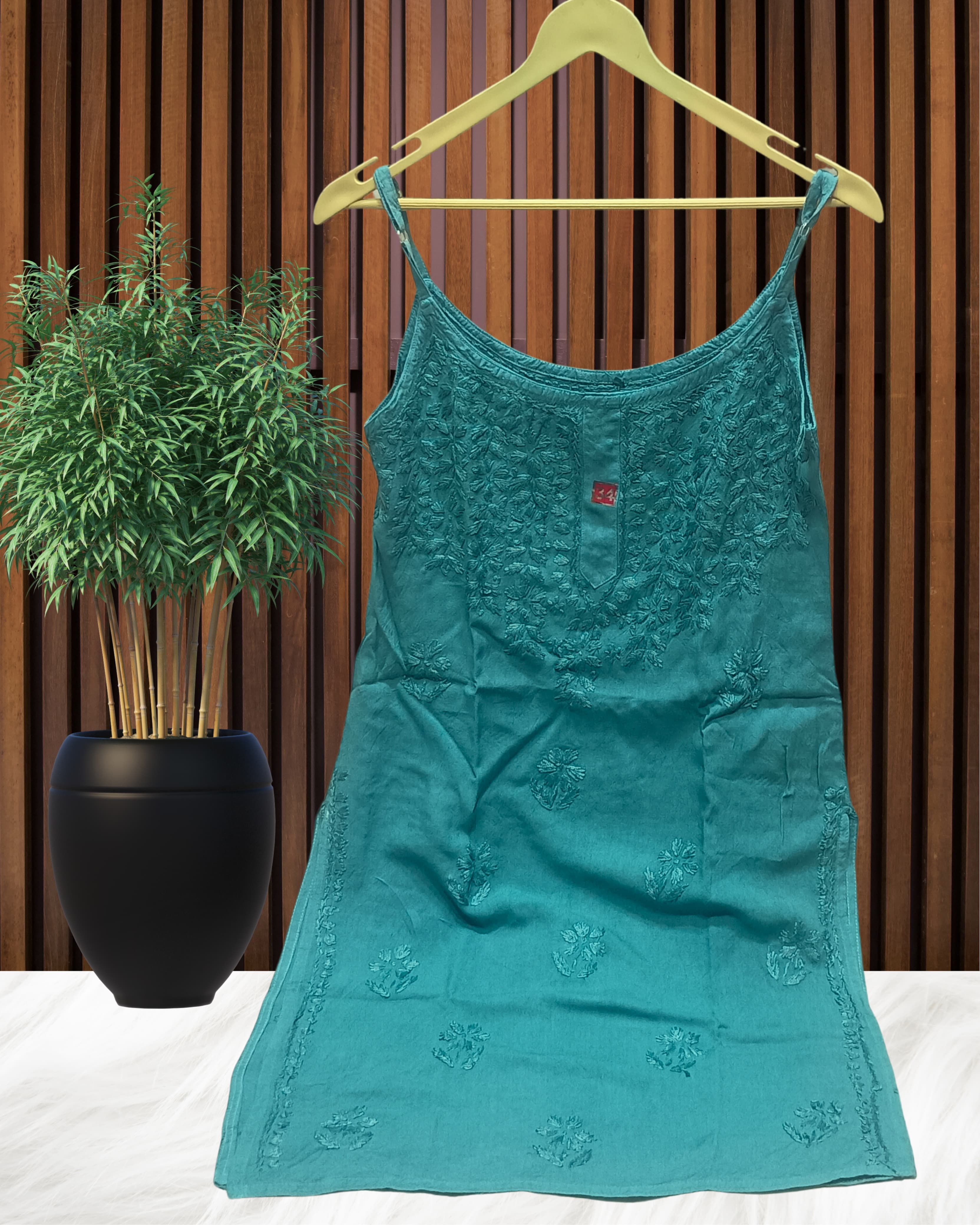 alt="Lucknowi chikankari tone to tone handwork sleeveless short top", alt="Noodle strap short chikankari top in premium rayon fabric", alt="Hand embroidered Lucknowi chikankari short top for women XXS to L", alt="Tone to tone chikankari work sleeveless kurti style top", alt="Premium rayon chikankari noodle strap short kurti top", alt="Lucknowi chikankari sleeveless short kurti with hand embroidery"